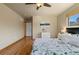 Bright bedroom featuring hardwood floors, a ceiling fan, and a calming neutral color scheme at 1430 S Lima St, Aurora, CO 80012