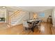 Elegant dining room with hardwood floors, modern table setting, and staircase access at 1430 S Lima St, Aurora, CO 80012