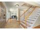 Open foyer with staircase, tile flooring, and view into the living area at 1430 S Lima St, Aurora, CO 80012