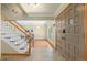 Bright foyer features tile flooring, staircase, and modern front door at 1430 S Lima St, Aurora, CO 80012