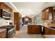 Open kitchen showcases stainless steel appliances, granite countertops, island, and a view to the living room at 1430 S Lima St, Aurora, CO 80012
