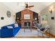 Cozy living room with brick fireplace, ceiling fan, hardwood floors, and comfortable seating at 1430 S Lima St, Aurora, CO 80012