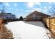 Large backyard with a snow-covered lawn and fence at 2492 S Jebel Way, Aurora, CO 80013