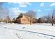 Brick house with a large yard and snowy landscape at 2492 S Jebel Way, Aurora, CO 80013