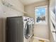 Convenient laundry room with washer, dryer, and overhead shelving at 2492 S Jebel Way, Aurora, CO 80013