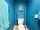 Cozy half bathroom with light tile floors and blue walls at 5690 W 79Th Ave, Arvada, CO 80003
