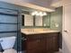 Bathroom featuring a double sink vanity, neutral countertops, and updated light fixtures at 5690 W 79Th Ave, Arvada, CO 80003