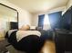 Cozy bedroom with a large mirror and a comfortable-looking bed dressed in black and white linens at 5690 W 79Th Ave, Arvada, CO 80003
