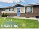 Charming single-story home featuring brick accents, light blue door, and well-maintained lawn at 5690 W 79Th Ave, Arvada, CO 80003