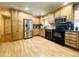 Well-maintained kitchen featuring stainless steel appliances, wooden cabinets, and laminate floors at 5690 W 79Th Ave, Arvada, CO 80003