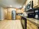 Well-maintained kitchen featuring stainless steel appliances, wooden cabinets, and laminate floors at 5690 W 79Th Ave, Arvada, CO 80003