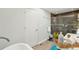 Bathroom showcasing a modern glass-enclosed shower, and a soaking tub at 2408 Irving St, Denver, CO 80211