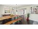 Elegant dining area with a unique wooden table, modern light fixture, and hardwood floors at 2408 Irving St, Denver, CO 80211
