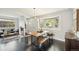Dining area with live edge table, hardwood floors and a large window at 2408 Irving St, Denver, CO 80211