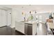 Bright kitchen with an island, stainless steel appliances, and view to the backyard at 2408 Irving St, Denver, CO 80211