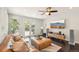 Cozy living room with a brown leather couch, a modern TV and doors leading to the outside area at 2408 Irving St, Denver, CO 80211