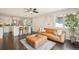 Bright living room and kitchen area with white cabinetry, hardwood floors, and a modern aesthetic at 2408 Irving St, Denver, CO 80211