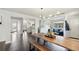 Bright, open-concept living and dining area with hardwood floors and modern lighting fixture at 2408 Irving St, Denver, CO 80211