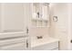 Bathroom vanity with a sink, storage cabinets, and a decorative mirror above at 25561 E 5Th Pl, Aurora, CO 80018