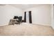 Bedroom featuring neutral carpet, ample floor space, a window, and a nearby door at 25561 E 5Th Pl, Aurora, CO 80018