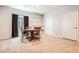 Dining area with a round wooden table and four chairs, complemented by built-in shelving at 25561 E 5Th Pl, Aurora, CO 80018