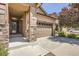 Inviting home featuring an attached two car garage, covered porch, and attractive stone accents on columns at 25561 E 5Th Pl, Aurora, CO 80018
