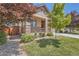 Charming home featuring a cozy porch, manicured landscaping and the stone veneer accents on the columns at 25561 E 5Th Pl, Aurora, CO 80018