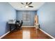 Bright home office features hardwood floors, blue walls, and natural light from window at 25561 E 5Th Pl, Aurora, CO 80018