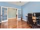 Office with blue walls features hardwood floors, French doors, and large desk area at 25561 E 5Th Pl, Aurora, CO 80018