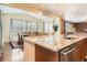 Bright kitchen features a large island with seating, granite countertops, stainless appliances, and hardwood floors at 25561 E 5Th Pl, Aurora, CO 80018