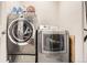 A convenient laundry room features modern washer and dryer, with cleaning supplies above at 25561 E 5Th Pl, Aurora, CO 80018