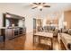 Spacious living room featuring hardwood floors and a large tv, seamlessly connecting with the kitchen at 25561 E 5Th Pl, Aurora, CO 80018