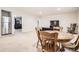 View of dining table and chairs next to a refrigerator and adjacent to a living room at 25561 E 5Th Pl, Aurora, CO 80018