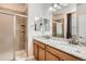 Primary bathroom features dual sinks, granite countertops, and glass-enclosed shower at 25561 E 5Th Pl, Aurora, CO 80018
