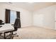 Bright office space with neutral carpet, a window, and a desk with a computer at 25561 E 5Th Pl, Aurora, CO 80018