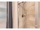 Enclosed shower with neutral tile and chrome fixtures at 25561 E 5Th Pl, Aurora, CO 80018
