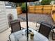 This backyard features a wooden fence, outdoor seating, and low maintenance landscaping at 6887 S Dover Way, Littleton, CO 80128