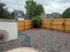 Backyard with a rock garden, a wooden fence, a shed and decorative foliage at 6887 S Dover Way, Littleton, CO 80128