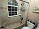 Bathroom with window, tile, and a shower over the tub at 6887 S Dover Way, Littleton, CO 80128
