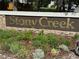 Attractive 'Stony Creek' community entrance sign surrounded by well-kept garden beds at 6887 S Dover Way, Littleton, CO 80128