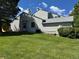 Side view of home with light siding, a well-manicured lawn, blue trim, and two chimneys at 6887 S Dover Way, Littleton, CO 80128