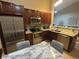 A well appointed kitchen featuring stainless steel appliances and marble dining table at 6887 S Dover Way, Littleton, CO 80128