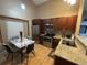 Kitchen with stainless steel appliances, cherry cabinets and marble table at 6887 S Dover Way, Littleton, CO 80128