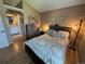 Inviting bedroom with wooden furniture and an ensuite bathroom for added privacy at 6887 S Dover Way, Littleton, CO 80128