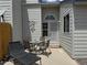 Exterior view of patio with table, chairs, a chaise lounge, and security door at 6887 S Dover Way, Littleton, CO 80128