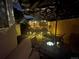 Back patio at night with patio table and chairs under lighted umbrella at 6887 S Dover Way, Littleton, CO 80128