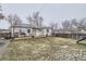 Backyard view of home, deck, and play area at 1840 Rowena St, Thornton, CO 80229