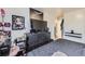 Bedroom with large TV, dresser, and window at 1840 Rowena St, Thornton, CO 80229