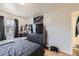 Bedroom with large TV, dresser, and window at 1840 Rowena St, Thornton, CO 80229