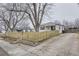 White Ranch home with wood fence and driveway at 1840 Rowena St, Thornton, CO 80229